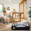 A couple is interacting with their dog in a bright, modern living room. A dog bed is placed in the foreground. Anteprima dell’immagine prodotto