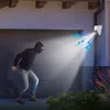 A burglar is attempting to break into a garage at night, and a security camera is detecting them. Produktbild-Vorschau