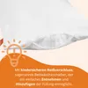 A close-up of a white pillow with a partially opened zipper showing the filling, with an orange graphic of a lightbulb and text overlay. Voir les images du produit