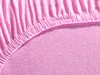 A close-up view of pink jersey fabric, showing the texture and elasticated edge of a fitted sheet. Produktbild-Vorschau