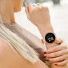 A woman's wrist wearing a smartwatch and holding keys. Produktbild-Vorschau