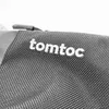 A close-up view of the brand logo on a black textured bag. Produktbild-Vorschau
