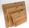 A set of three wooden cutting boards of varying sizes, stacked diagonally. Produktbild-Vorschau