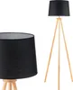 A floor lamp with a black shade and a wooden tripod base is shown against a white background. A close-up of the lampshade is also visible on the left. Podgląd zdjęcia produktu
