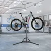 A bicycle repair stand with a bicycle mounted on it, in a garage setting. Náhled obrázku produktu