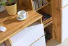 A close-up view of a wooden desk with a white cup and saucer, a white computer mouse, and a woven basket with a plant. Náhled obrázku produktu