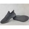 A pair of gray Puma Softride ONE4ALL sneakers are displayed on a light gray, textured surface. One shoe is shown from the side, while the other is shown from the sole. Produktbild-Vorschau