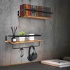 Two wooden shelves mounted on a concrete wall, decorated with books, a plant, a mug, reed diffuser, sunglasses, and headphones. Náhled obrázku produktu