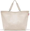 A beige tote bag with a textured, fluffy exterior and a smooth beige trim and handles. Voir les images du produit