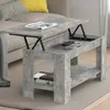 A lift-top coffee table with a concrete finish is shown in a living room setting next to a sofa. Voir les images du produit