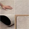 A collage of four images showing different views of a beige rug, including a hand touching the surface and a close-up of the edge. Náhled obrázku produktu