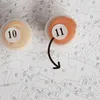 Two paint pots labeled '10' and '11' are shown on a canvas with numbered sections for a paint-by-numbers kit. An arrow indicates that paint pot '11' is to be used for sections marked with '11'. Produktbild-Vorschau