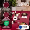 A table set for dinner with a red tablecloth, wine glasses, food, and decorative elements. Produktbild-Vorschau