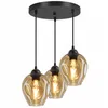A three-light pendant chandelier with amber glass shades hangs from a black ceiling mount. Produktbild-Vorschau