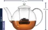 A clear, professional studio shot of a glass teapot filled with amber-colored liquid and tea leaves, with measurement indicators on the side and top. Produktbild-Vorschau