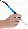 A hand holding a soldering iron. Voir les images du produit