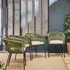 Four khaki-colored garden chairs with beige cushions are arranged on a light brown rug on a patio, with a glass-paneled wall and a brick wall in the background. Produktbild-Vorschau