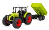 A toy tractor with a trailer, shown from a three-quarter front angle on a white background. Produktbild-Vorschau