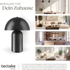 A collage showcasing a black retro-style table lamp and lifestyle images of it in different room settings (dining room, living room, kitchen, bedroom). Produktbild-Vorschau