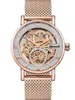 A close-up, front-facing studio shot of a skeletonized automatic wristwatch with a rose gold case and mesh band. Náhled obrázku produktu
