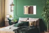 A bedroom scene with a bed, dresser, and a large plant. Produktbild-Vorschau