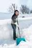 A woman is shoveling snow in a snowy environment. Náhled obrázku produktu