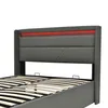 A close-up view of a grey upholstered bed frame with a red LED light strip at the headboard. Produktbild-Vorschau