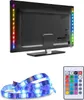 The back of a TV with LED RGB light strips attached to the sides, along with a separate LED strip and a remote control. Náhľad obrázku produktu