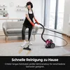 A woman is vacuuming a rug in a living room. Produktbild-Vorschau
