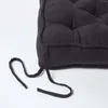 Close-up of a dark grey cushion with ties. Anteprima dell’immagine prodotto
