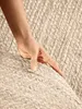 A hand touching a braided jute rug. Anteprima dell’immagine prodotto