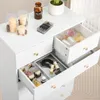 A white dresser with drawers open, showing various beauty products and decorative items. Produktbild-Vorschau