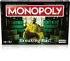 The image shows the Monopoly Breaking Bad board game box, featuring a character from the show in a yellow hazmat suit, surrounded by stacks of money. Produktbild-Vorschau
