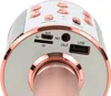 A close-up view of the top ports and buttons of a pink and rose gold karaoke microphone. Podgląd zdjęcia produktu