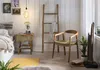 A bedroom scene featuring a nightstand, chair, and ladder. Produktbild-Vorschau