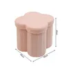 A pink clover-shaped ottoman with three cylindrical legs, shown from a slightly elevated angle with dimensions indicated. Podgląd zdjęcia produktu