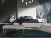 A modern bedroom with a large bed, bedside tables, and a bench. Produktbild-Vorschau