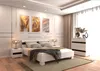 A modern bedroom with a white bed, nightstands, and artwork on the wall. Náhled obrázku produktu