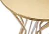 A close-up of a gold table with a decorative base. Produktbild-Vorschau