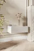 A modern bedroom scene with a white floating nightstand next to a bed. Náhled obrázku produktu
