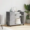 A grey side table with wheels is shown in a room with a sofa and a plant. Produktbild-Vorschau