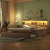 A bedroom scene with a wooden bed and a pull-out guest bed, illuminated by LED lighting. Produktbild-Vorschau