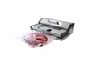 A vacuum sealer with a piece of meat inside a plastic bag. Podgląd zdjęcia produktu