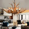 A living room with a chandelier, chairs, and a fireplace. Podgląd zdjęcia produktu