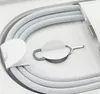 A close-up view of a white braided USB-C charging cable and a SIM card ejector tool, neatly arranged in a white product box. Produktbild-Vorschau