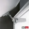Close-up of a metal hinge mechanism, likely for a cabinet or furniture, attached to white and dark gray surfaces. Produktbild-Vorschau
