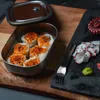 A bento box with sushi and octopus sashimi on a wooden board. Podgląd zdjęcia produktu