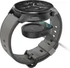 A smartwatch is shown being charged by a wireless charging puck. Náhled obrázku produktu