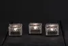 Three illuminated ice cube-shaped LED lights are arranged in a row on a dark surface. Podgląd zdjęcia produktu