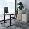 An office setting with a standing desk, chair, and storage unit. Náhled obrázku produktu